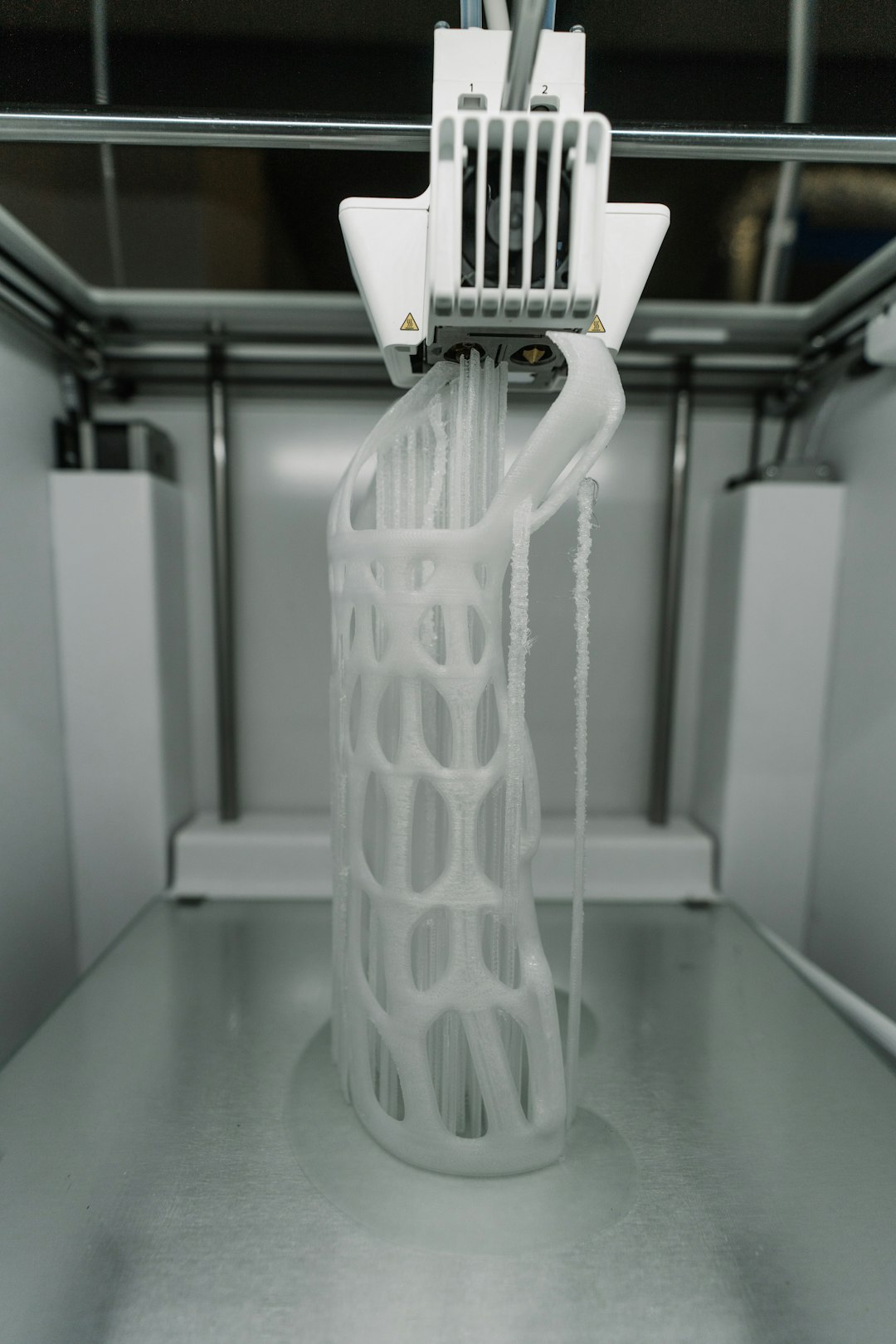 3D printer with a print showing warping on the bed