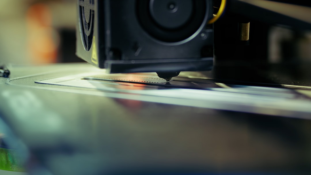 Close-up view of a 3D printer nozzle and hotend assembly